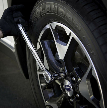Close-up of a car tire with a wrench tightening a lug nut, featuring a Polandair tire.