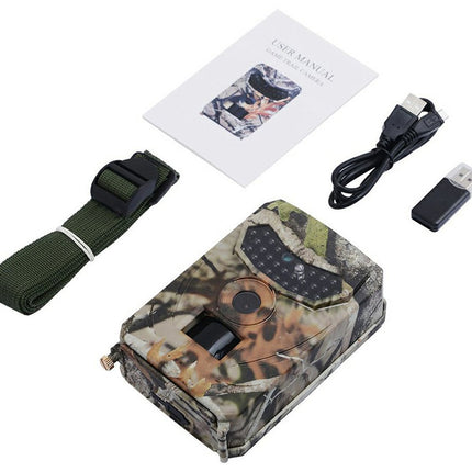 Camouflage hunting camera with strap, USB cable, and manual on a white background