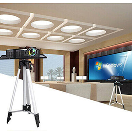 Camera on a tripod with a screen displaying Windows logo in an indoor setting.