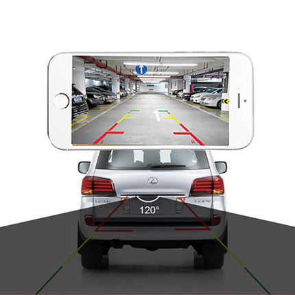 A smartphone showing a rear parking-lane camera feed is positioned above the rear of a silver SUV on a white background with a dark gray floor. Red and yellow guide lines are overlaid on both the phone screen and the vehicle to demonstrate a parking assist feature.