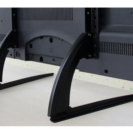 Close-up of a TV stand with black metal legs on a white surface.