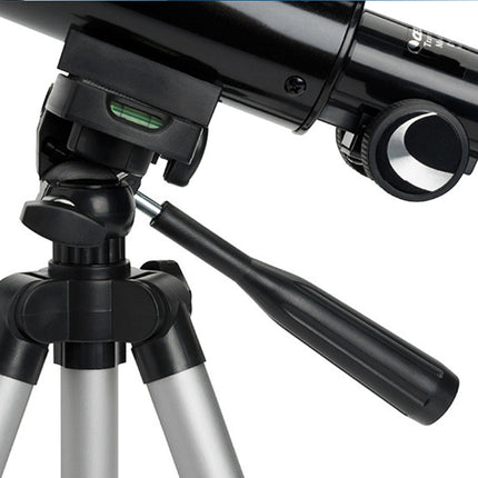 Black telescope on a tripod against a white background