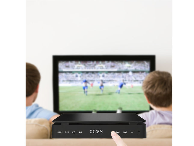 Two children watching a soccer match on a television with a remote control in front.