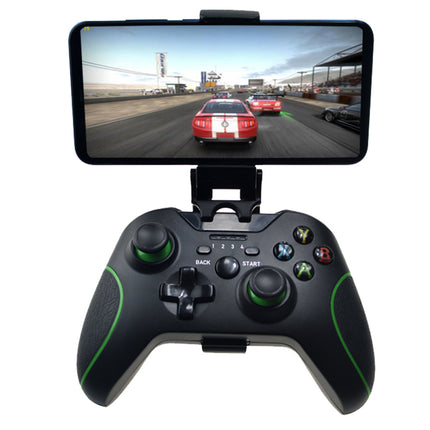 A black wireless gaming controller with green accents and a built-in phone mount, shown holding a smartphone displaying a racing game. The controller has Xbox-style buttons and joysticks.