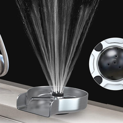A chrome faucet-mounted spray shower device shown with water spraying upward, alongside a circular inset detail of the internal spray head, on a dark background.