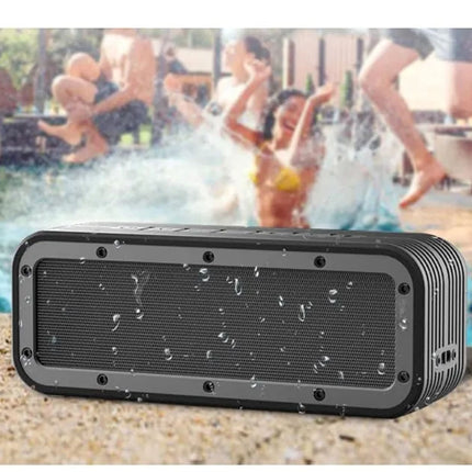 Black portable speaker with water droplets on a poolside background