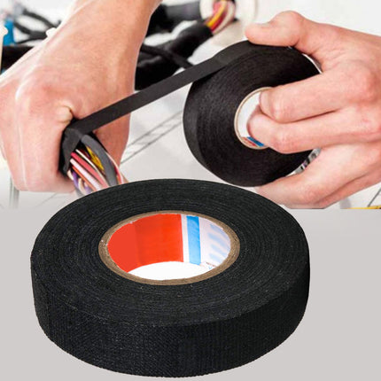 Person using black electrical tape on a white background
