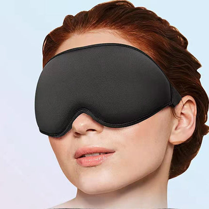 Person wearing a black sleep mask against a light blue background