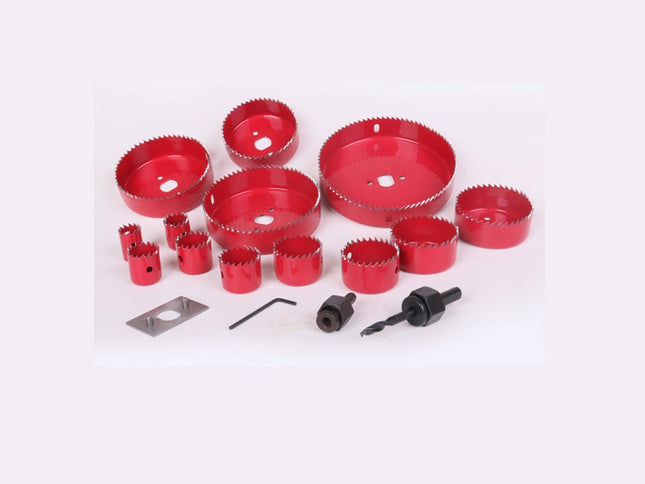 Set of red hole saws and related tools on a white background