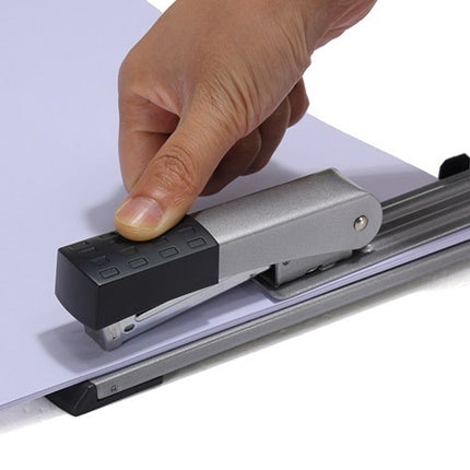 Hand using a paper trimmer on a white background