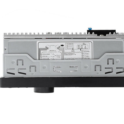 A silver and black automotive electronic control module with a central white label containing technical specifications and diagrams, isolated on a white background.