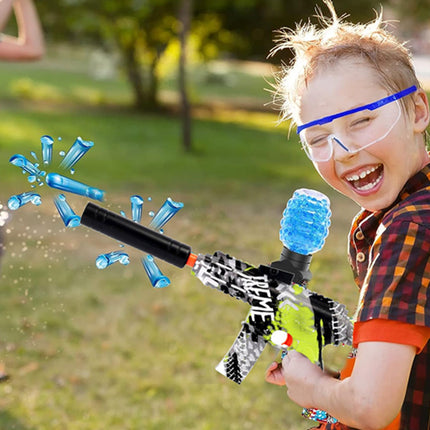 Child playing with a water gun in a park