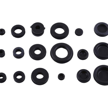 Collection of various black rubber washers on a white background