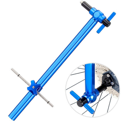 A blue metal bicycle wheel alignment tool with a T-handle and adjustable arm, shown on a white background with a circular inset demonstrating use on a bicycle wheel.