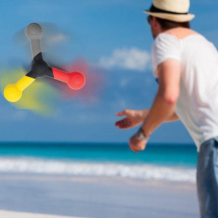 Person playing with a colorful disc on a beach