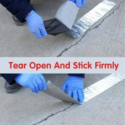 Person applying a strip of reflective material to a concrete surface with text 'Tear Open And Stick Firmly'.