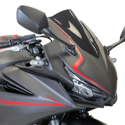 Close-up of a motorcycle with a black and red design on a white background