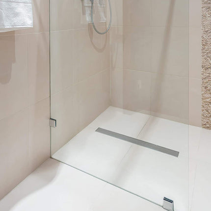Modern shower area with glass enclosure and tiled walls.