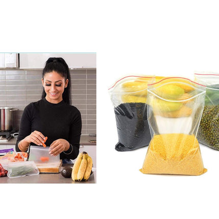 Woman preparing food in a kitchen with reusable food storage bags shown on the right.
