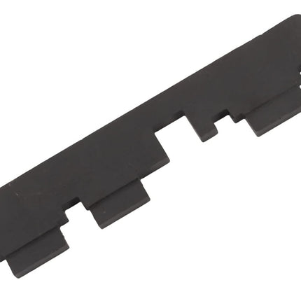 Black plastic strip with multiple notches on a white background