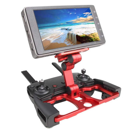 A red and black drone remote controller with an attached flip-down screen displaying a beach landscape, isolated on a white background.