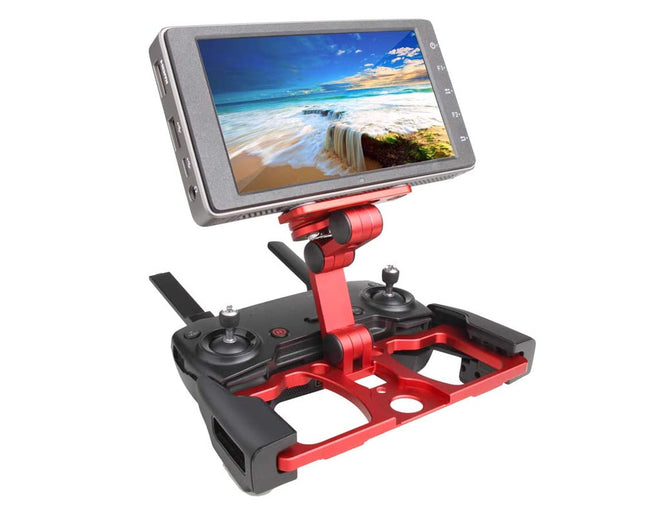 A red and black drone remote controller with an attached flip-down screen displaying a beach landscape, isolated on a white background.