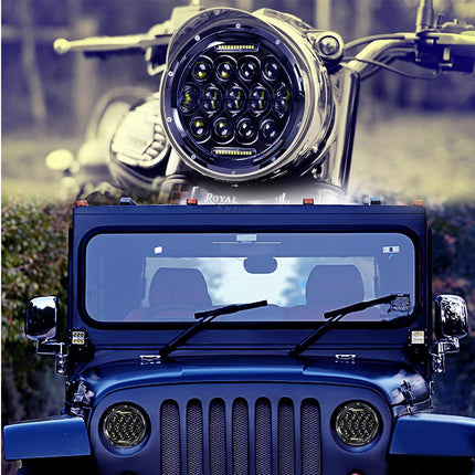 Blue Jeep with large round headlight on a blurred natural background