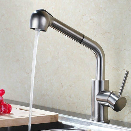 Stainless steel kitchen faucet with water flowing into a sink, with a neutral background.