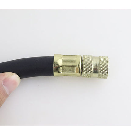 Black hose with brass fitting held by a hand on a white background