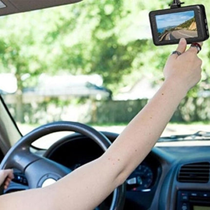 Person inside a car using a dashboard camera to record the road.