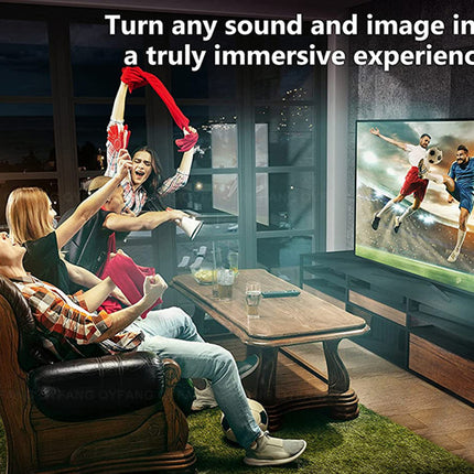 Three people in a living room watching a soccer game on a large TV screen, with one person cheering and holding a red scarf. The TV displays soccer players in action.