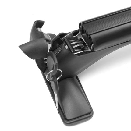 Close-up of a black plastic accessory with a key ring and key, attached to a textured black cylindrical component, on a white background.