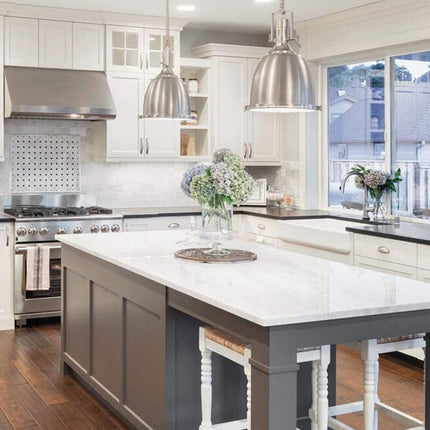 Modern kitchen with white cabinets, stainless steel appliances, and a central island.