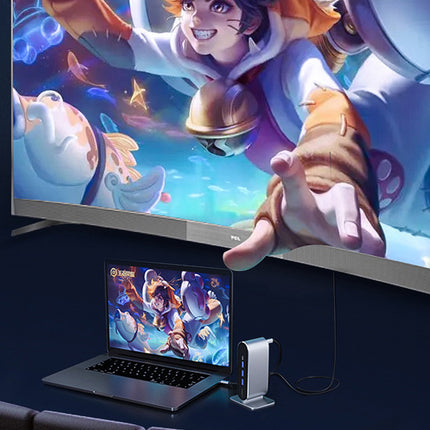 Laptop displaying a game on a screen with a large TV showing a similar game scene.