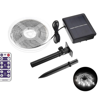 Solar LED strip light kit with remote control, solar panel, and stakes on a white background