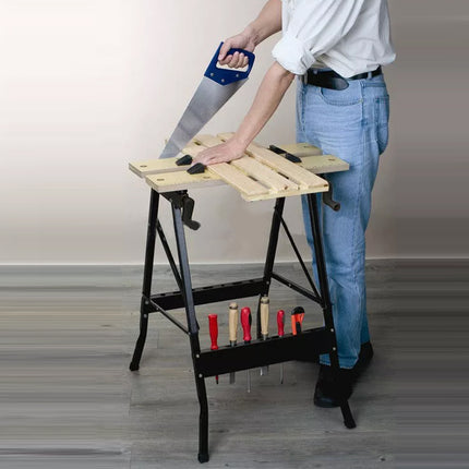 Person using a folding workbench with tools on a plain background