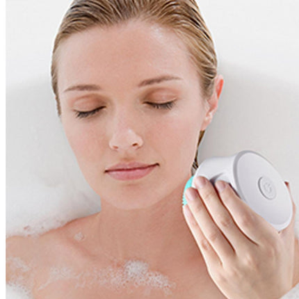 Woman using a skincare device on her face with a white background