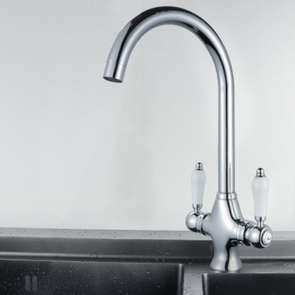Chrome kitchen faucet with two handles on a sink against a light gray background
