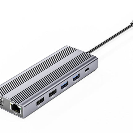 A silver aluminum 15-inch USB-C hub with a ribbed top design, featuring multiple USB-A and USB-C ports, an RJ45 Ethernet port, and a VGA output port, shown on a white background.