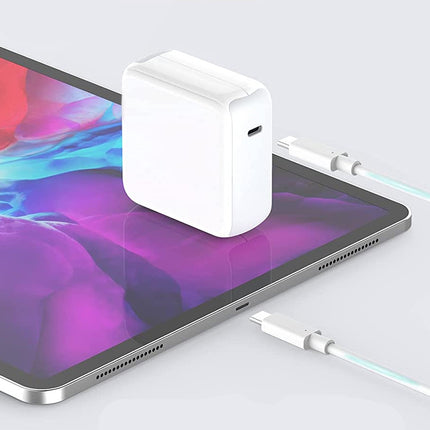 Tablet with a power adapter and cable on a light gray background