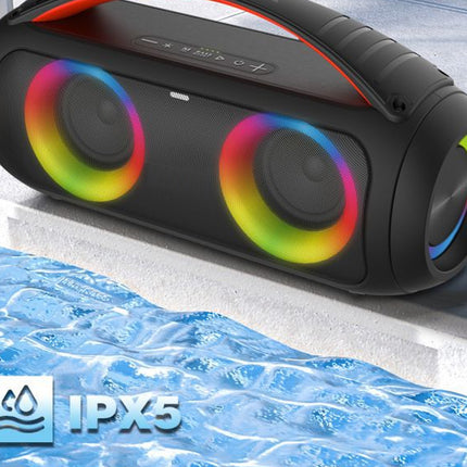 Black portable speaker with colorful lights on a concrete surface with water splashes, featuring IPX5 rating.
