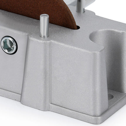 Metal sanding block with sandpaper on a white background