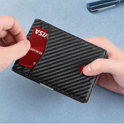 Carbon fiber wallet with a Visa card being inserted on a light blue background