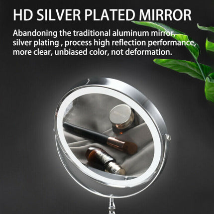 Silver-plated mirror with cosmetic items on a dark background with green leaves.