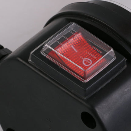 Close-up of a black device with a red switch on a gray background