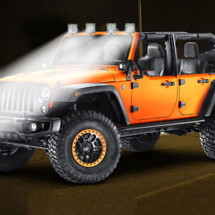 Orange off-road vehicle with additional lights on a dark background