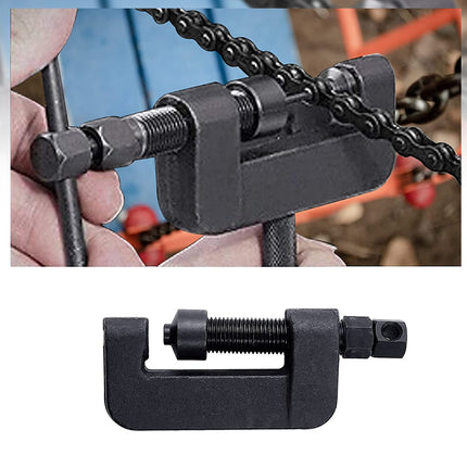 Close-up of a chain breaker tool being used on a bicycle chain.