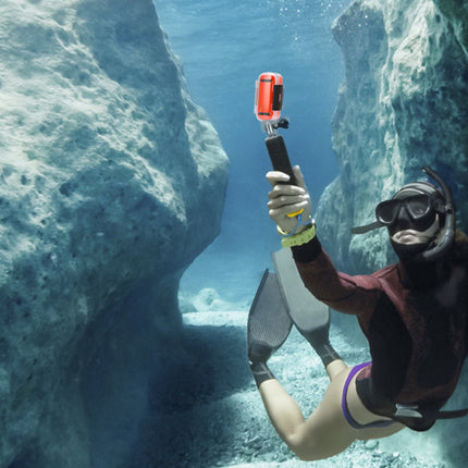 Person scuba diving underwater with a camera stabilizer