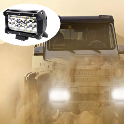 Off-road vehicle with a large light bar on a desert background