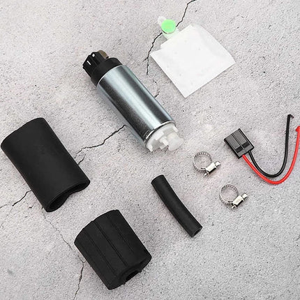 Collection of car fuel pump parts on a concrete surface